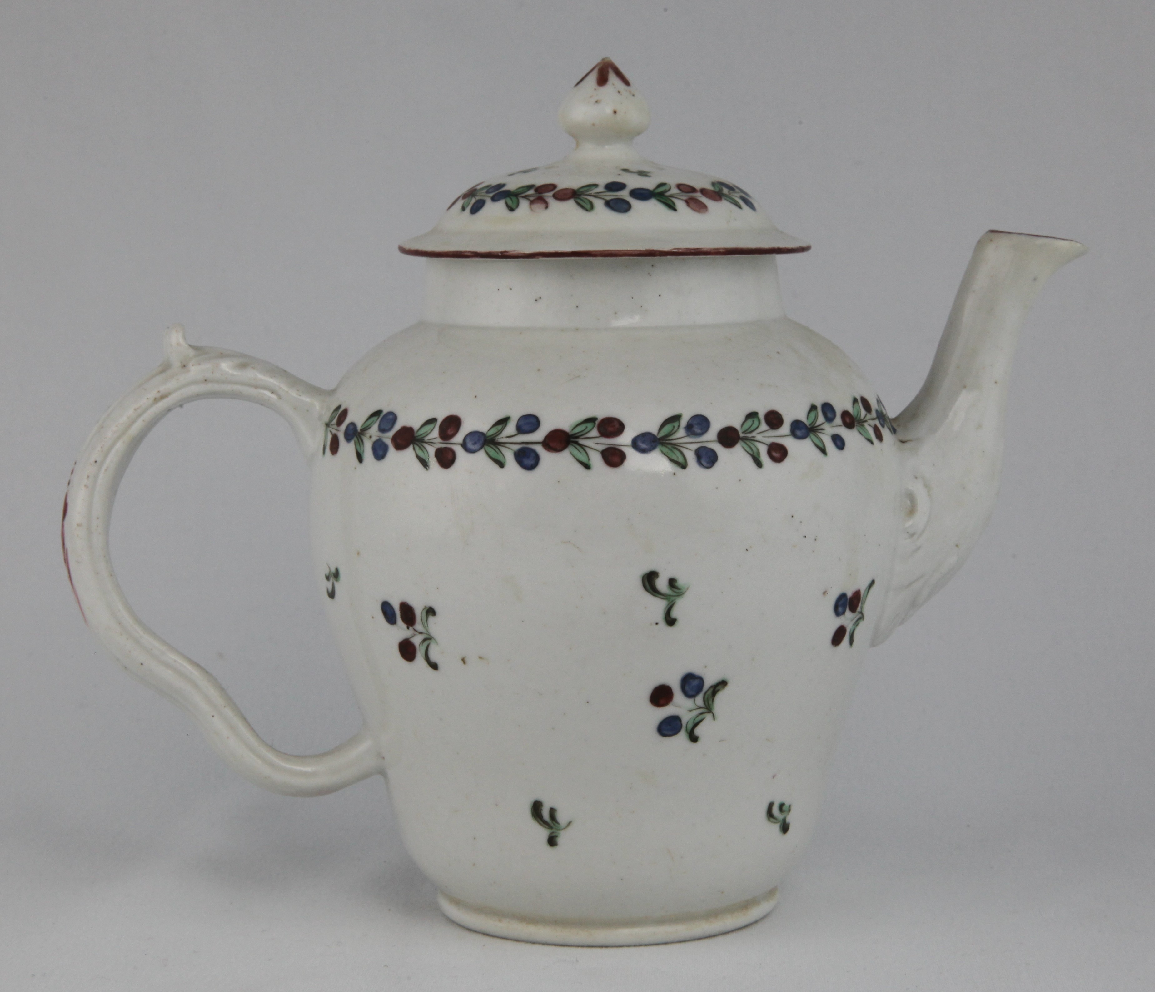 Teapot, decorated by No mark, A Bristol teapot and cover, the cover with conical finial, the pot with moulded spout and ear-shaped handle, painted simply in muted colours with a band of leaves and scattered leaves and flowers, all under a red rim line, unusual P mark — Plymouth & Bristol porcelain piece 1677