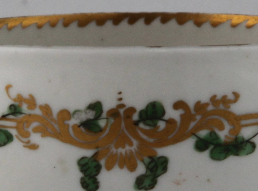 Gilt scrolls under angular gilt rim