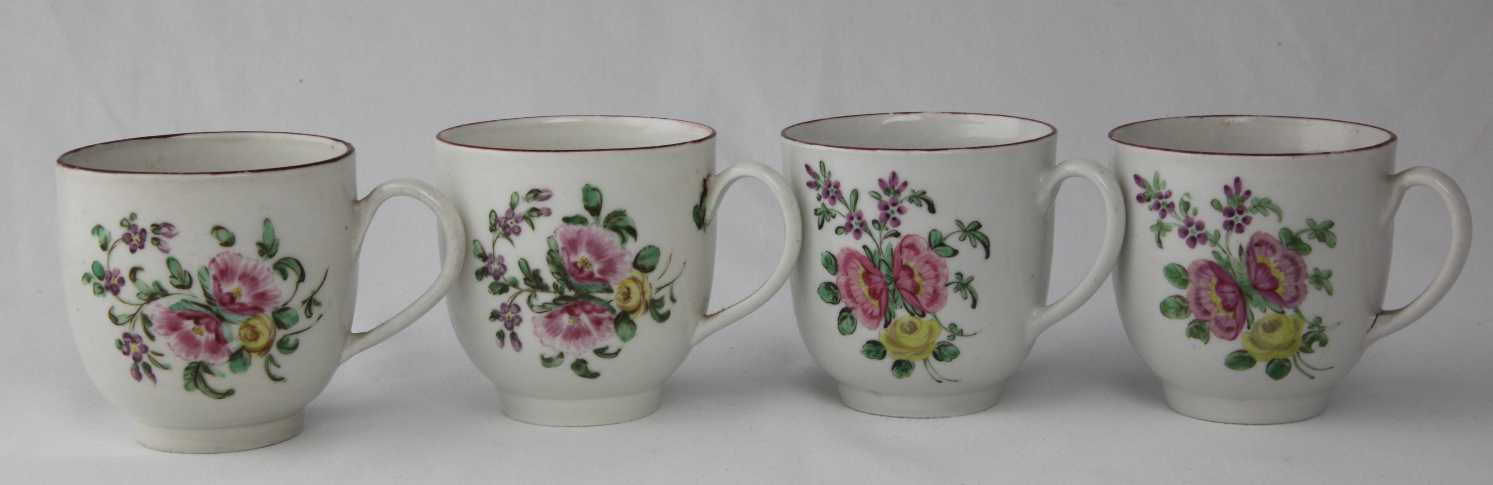 Two pairs of cottage Bristol cups featuring a bouquet with a pair of pink auriculas and a yellow rose. The two on the left decorated by 16, the pair on the right by 7.