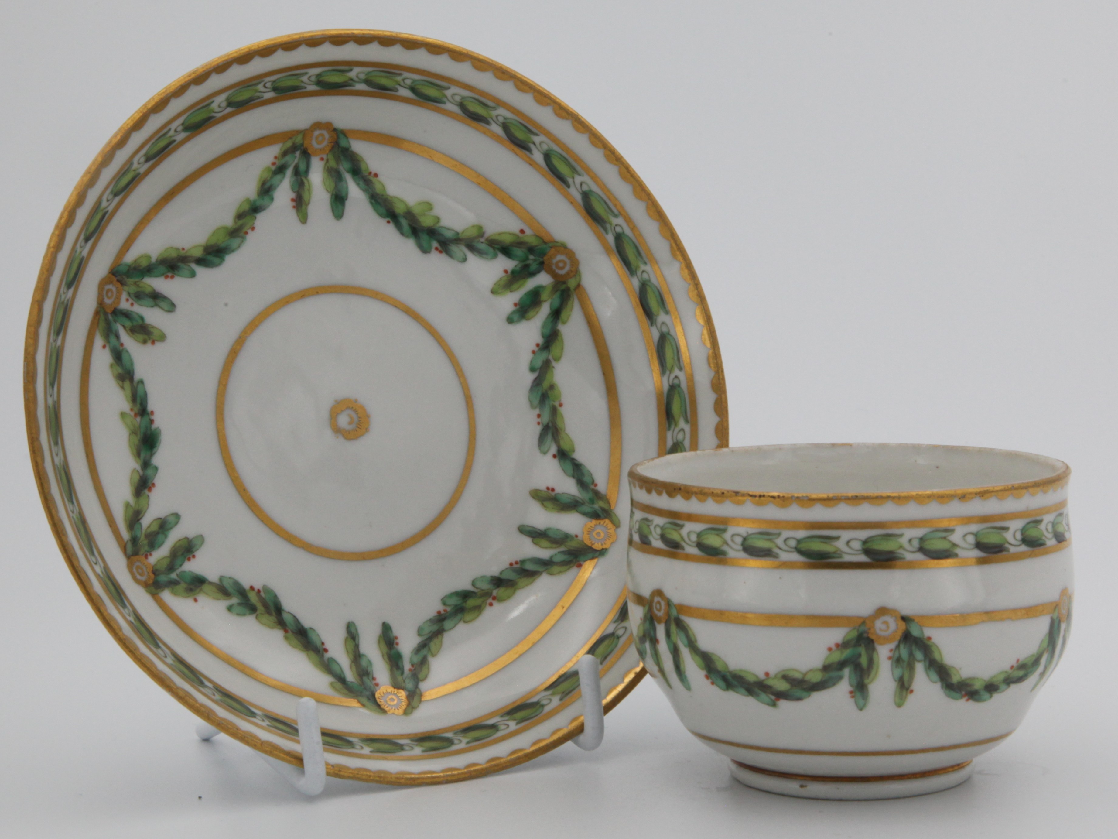 A Bristol teacup and saucer with laurel swags.