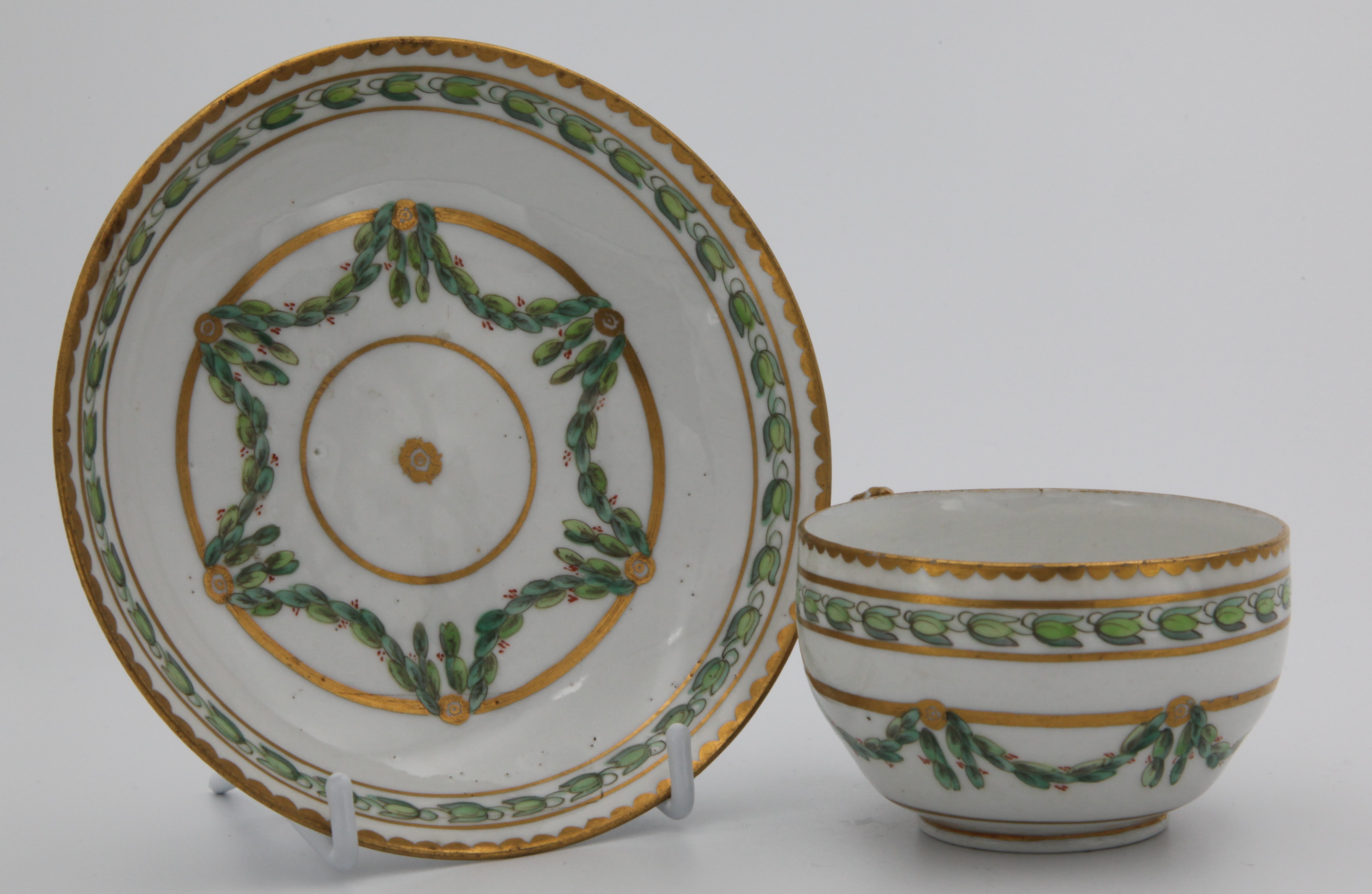 A Bristol tea cup and saucer with laurel swags.