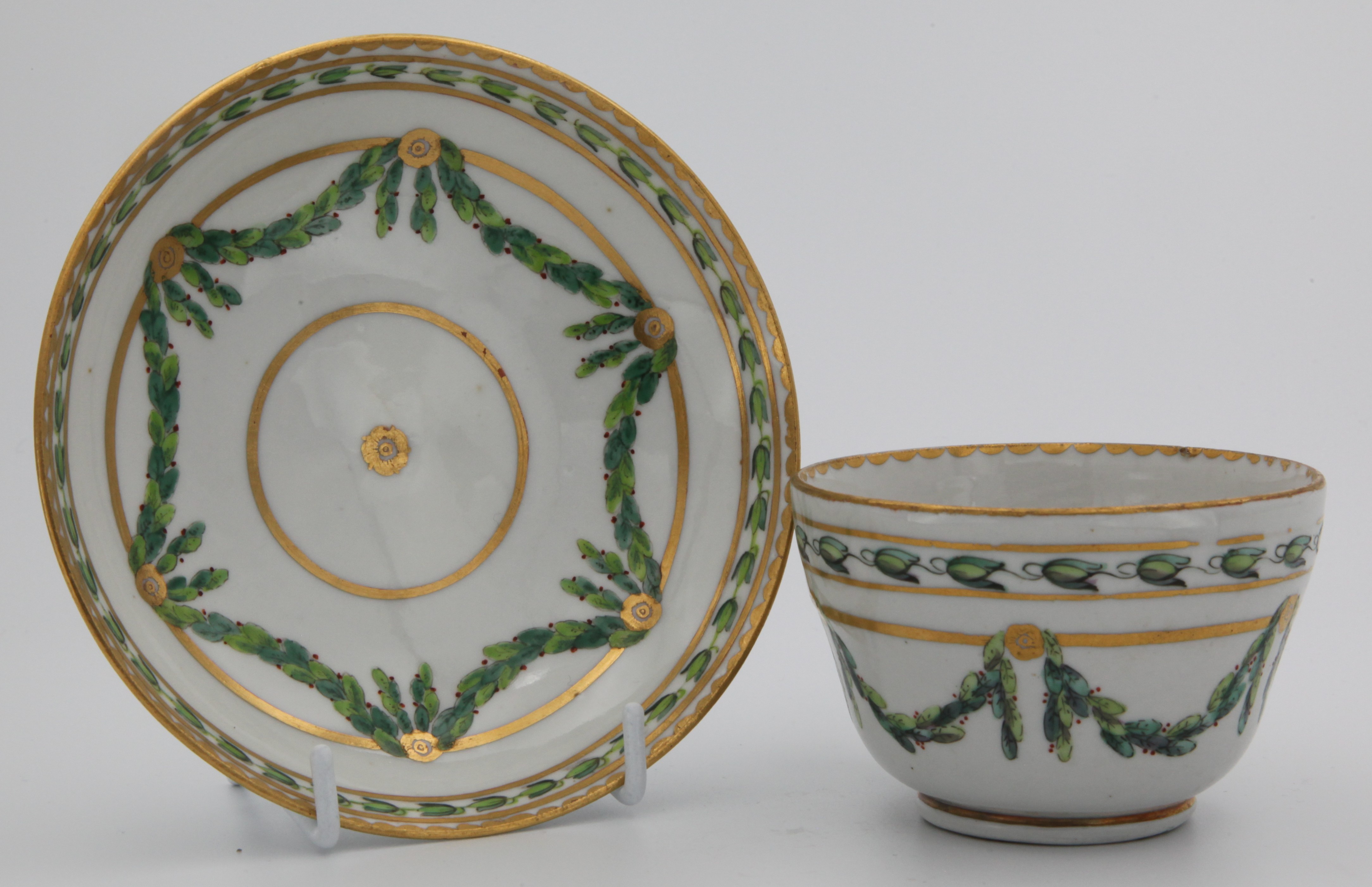 A Bristol teacup and saucer with laurel swags.