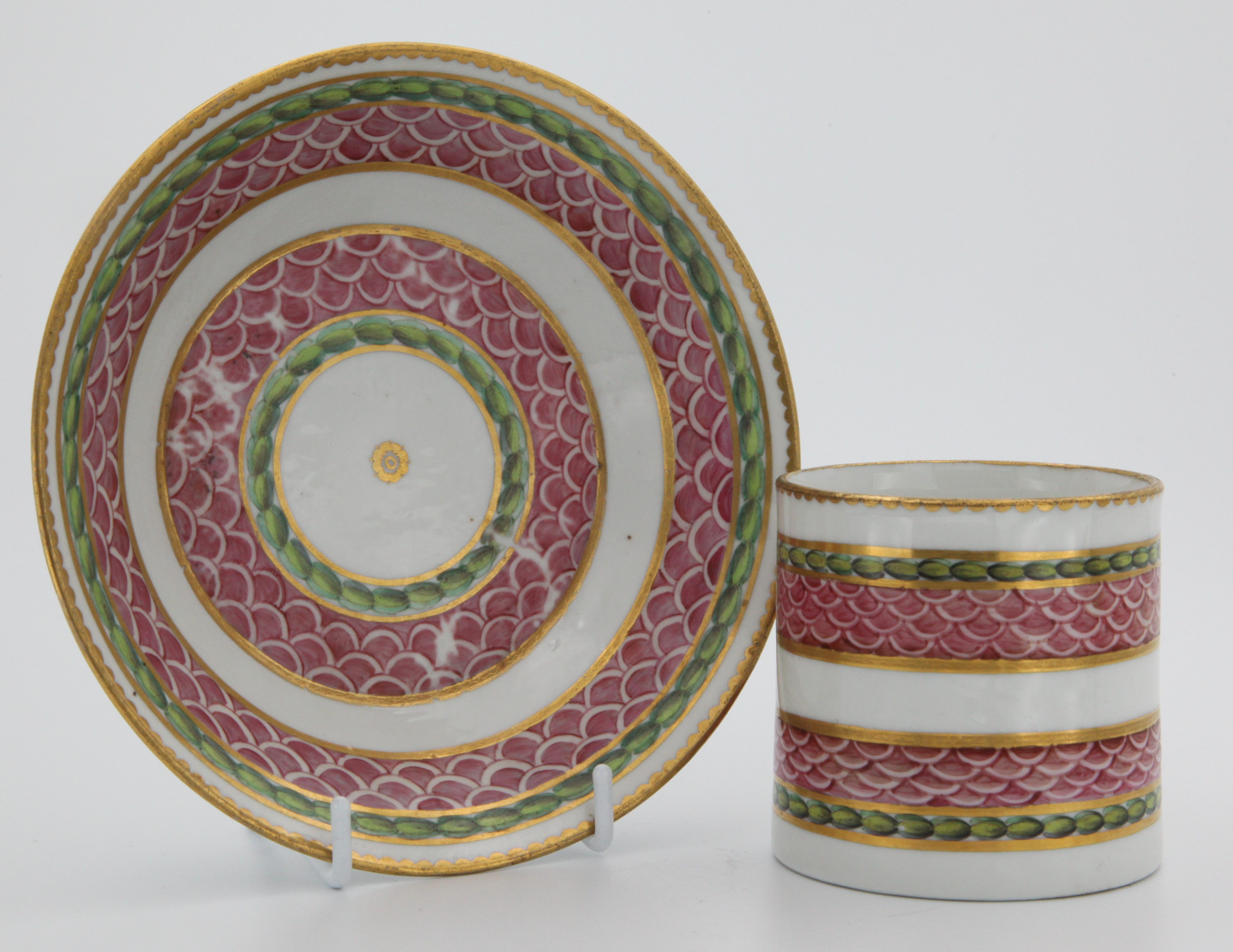 A fine Bristol coffee can and saucer with bands of pink scale, gilding and laurel.