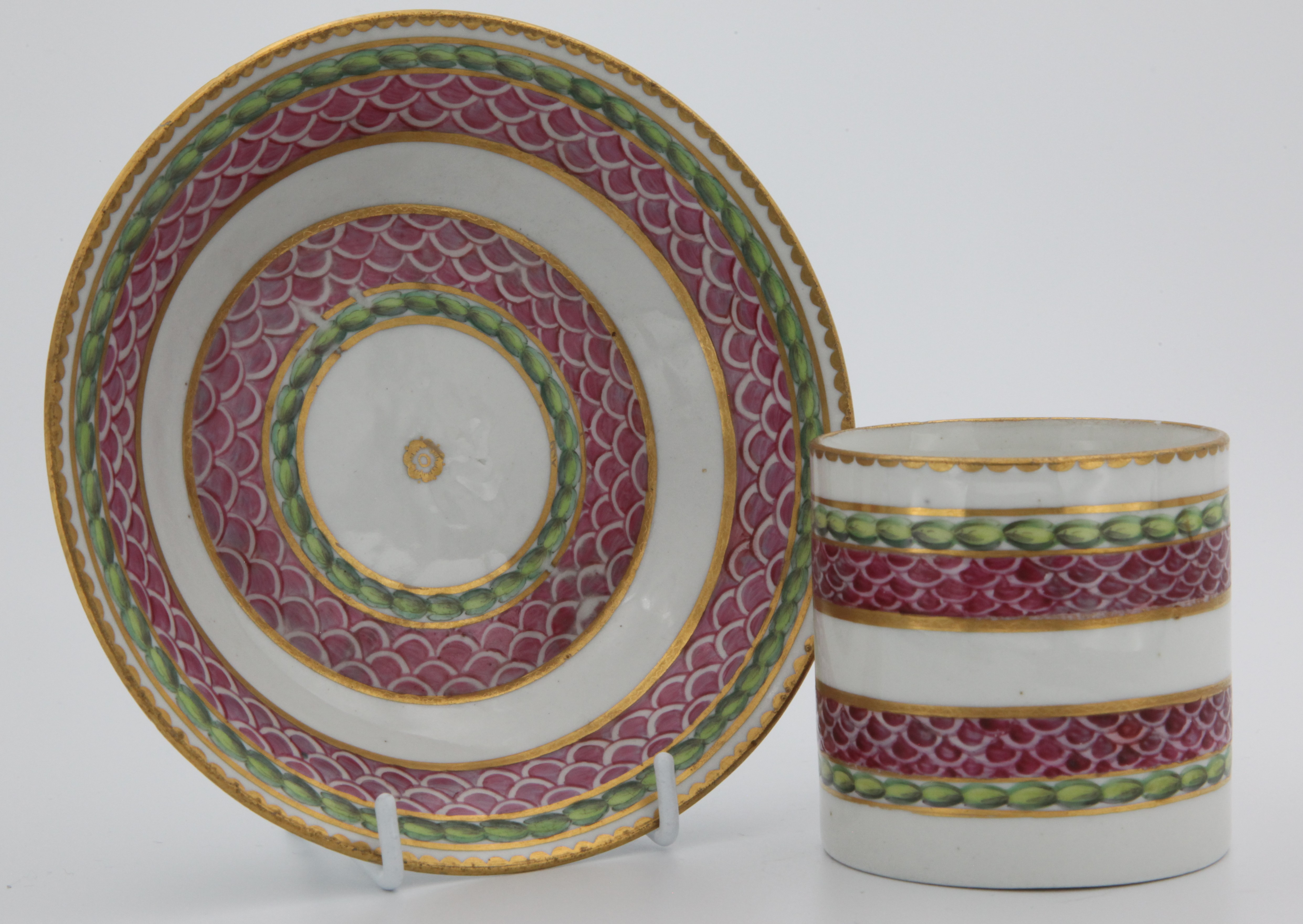 A fine Bristol cabinet cup and saucer with bands of pink scale, gilding and laurel.