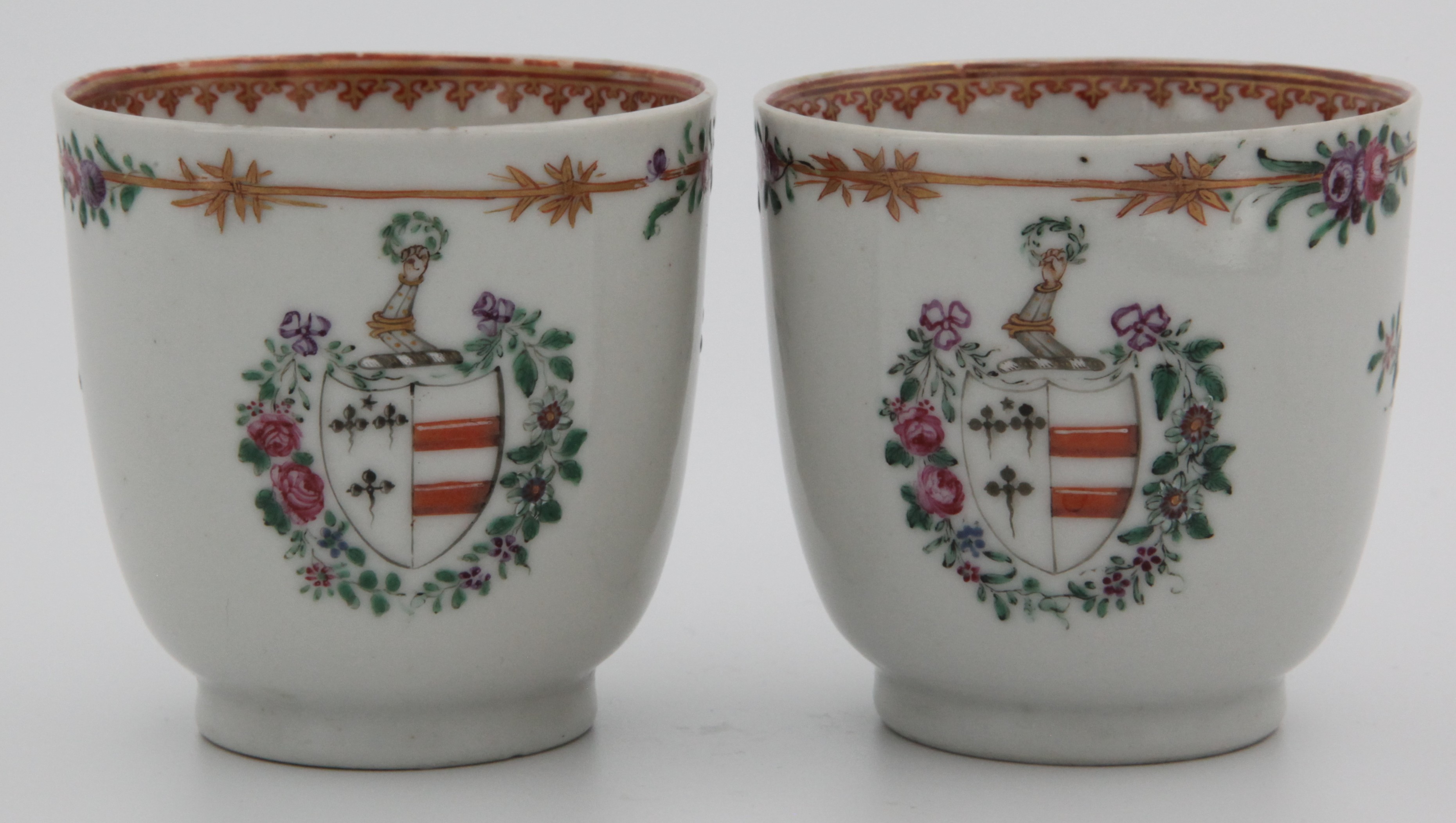 A pair of Chinese export armorial cups with the arms of Champion
