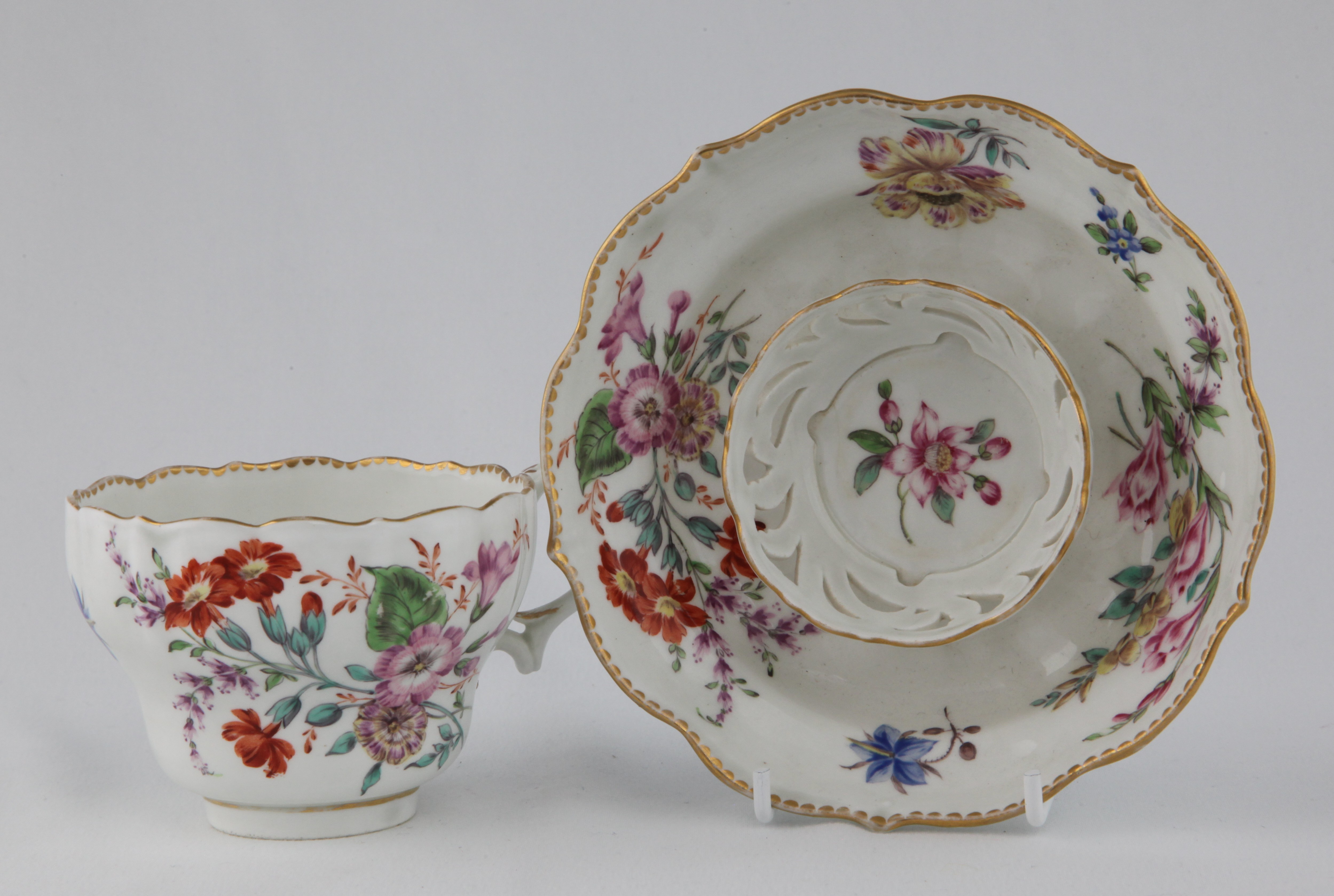 A colourful Bristol teacup with trembleuse saucer