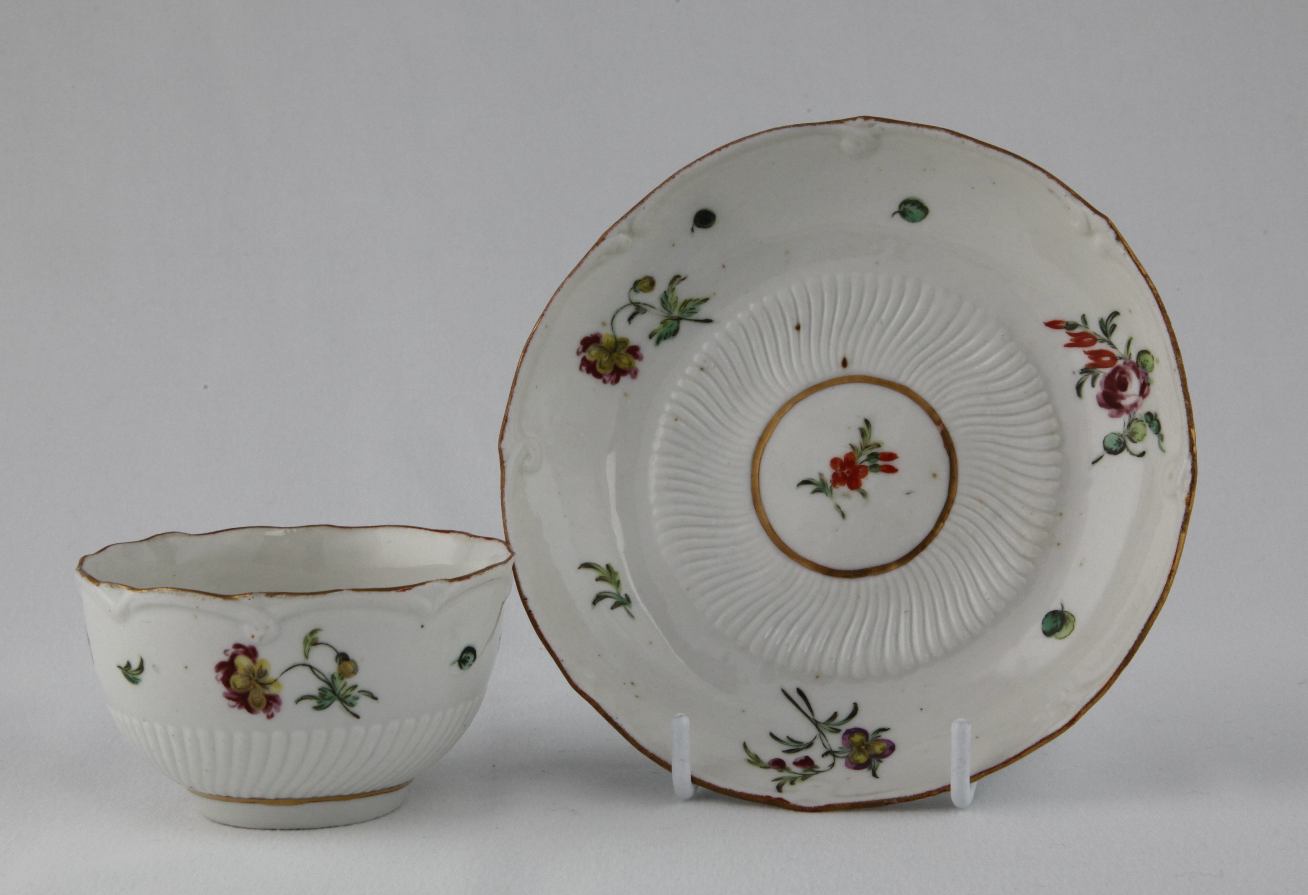 A tea bowl and saucer with spiral moulding