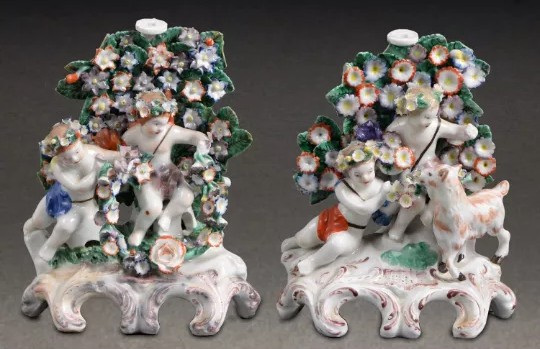 A pair of Plymouth figural candlesticks